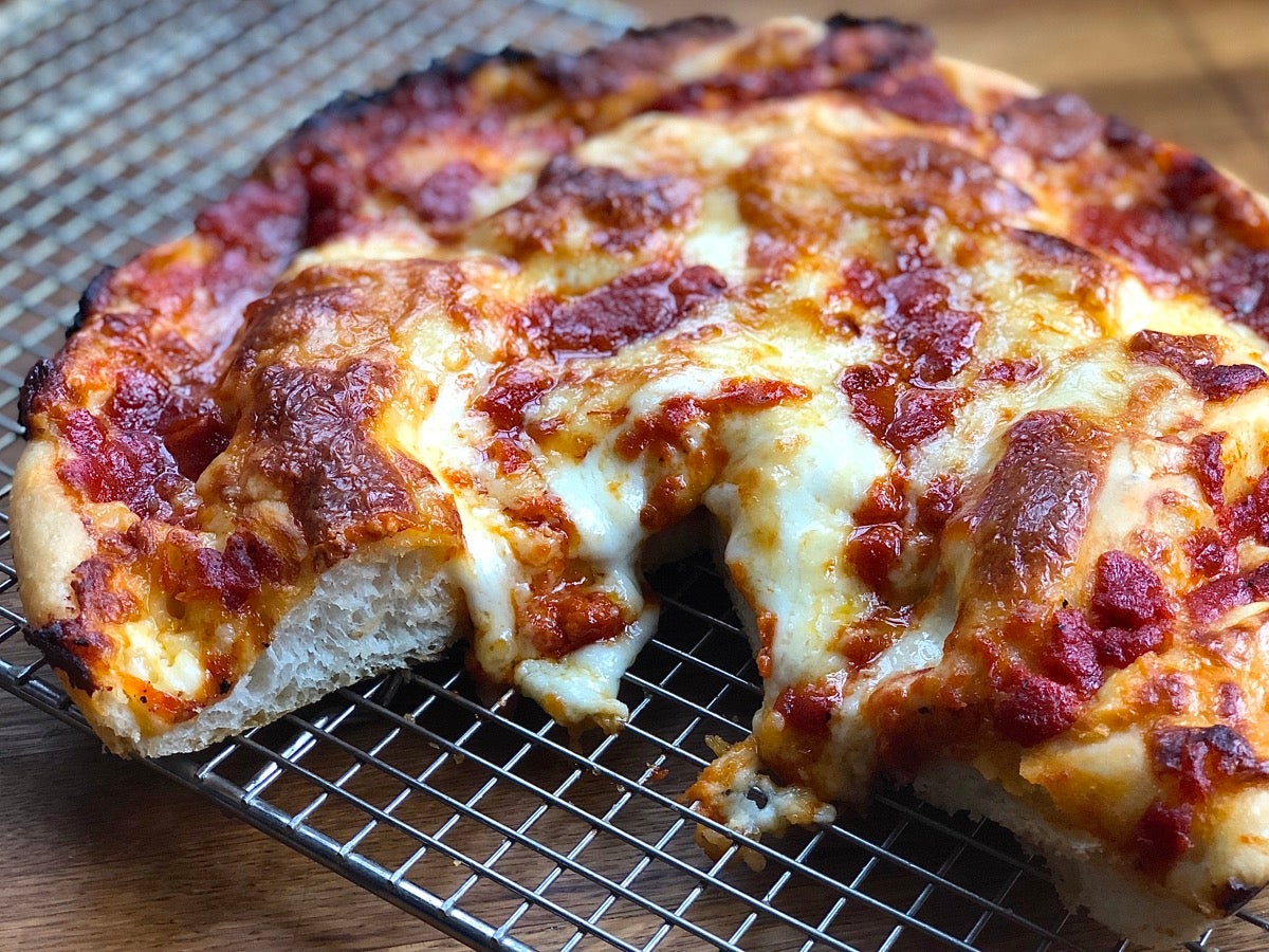 Crispy Cheesy Pan Pizza topped with mozzarella, provolone, and cheddar cheeses.