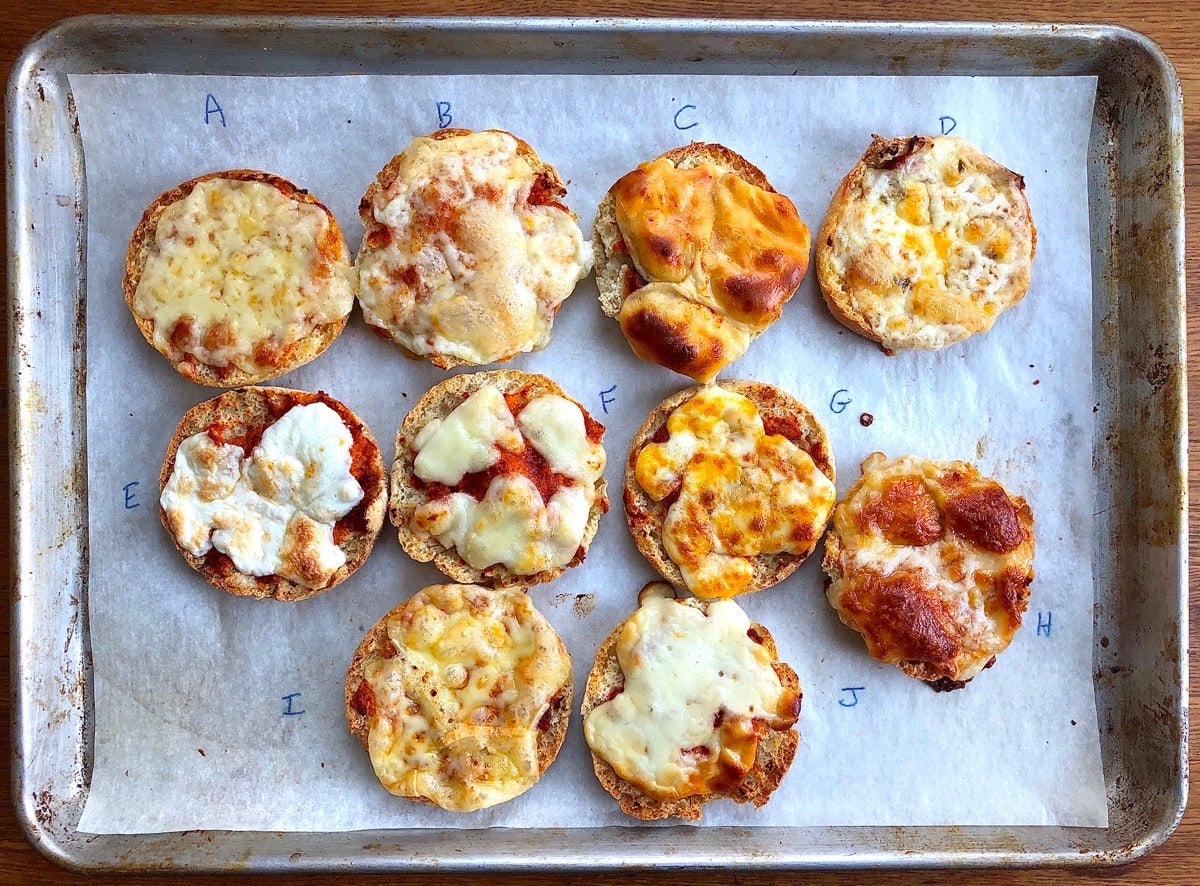 10 English muffin halves topped with sauce and different cheeses, baked until cheeses have melted.