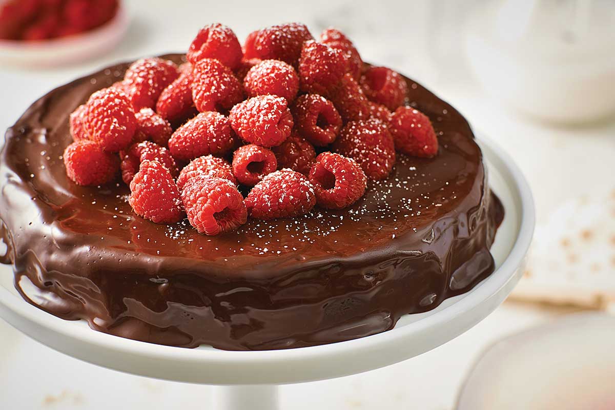 A flourless chocolate cake topped with raspberries