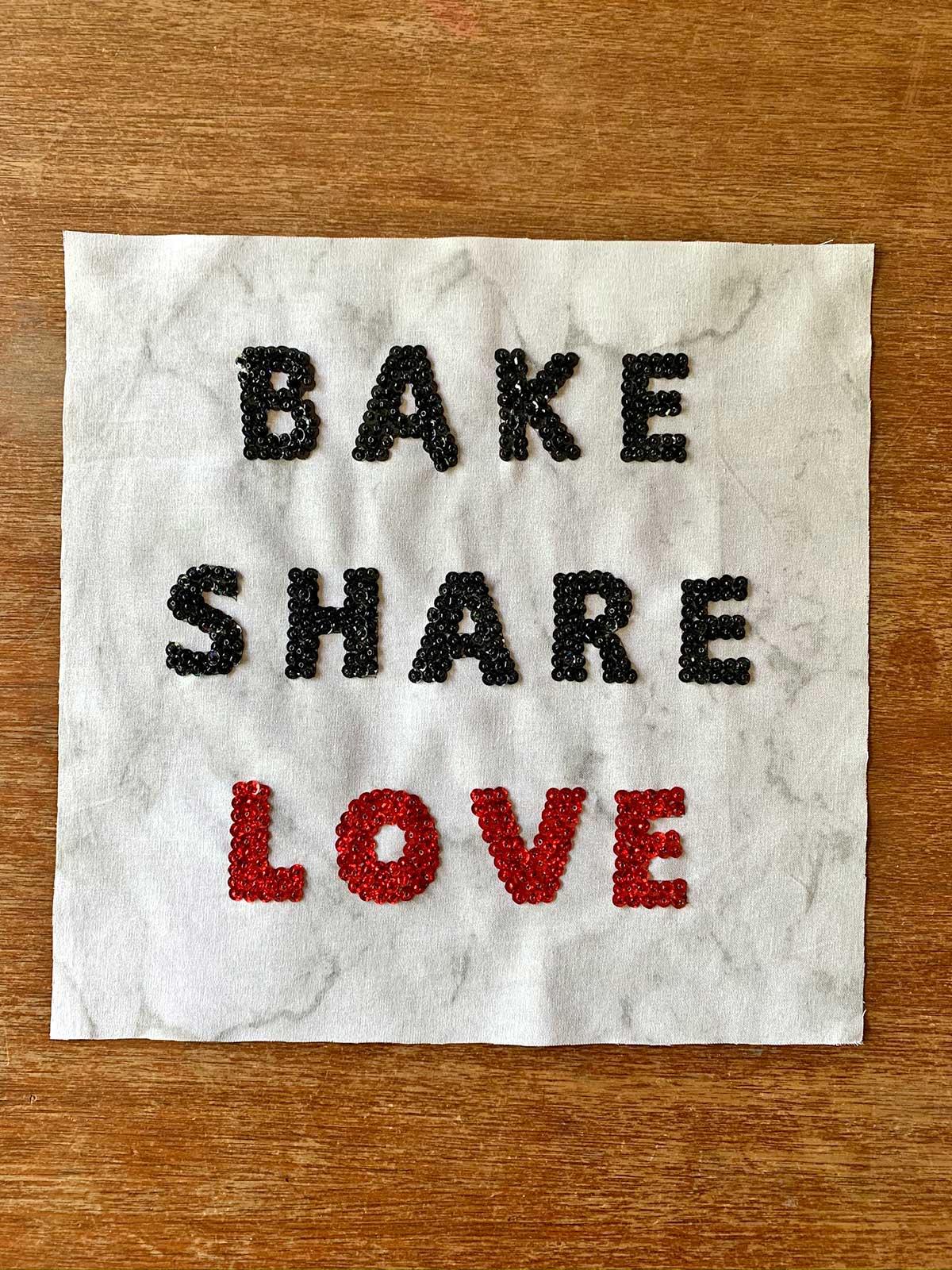 Molly's quilt square, with the words "Bake, Share, Love"
