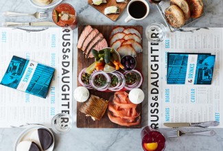 Overhead view of Russ and daughters menu and smoked fish platter