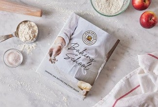 Baking School cookbook on a baking work surface
