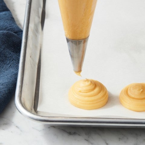 Piping cream puff batter - select to zoom