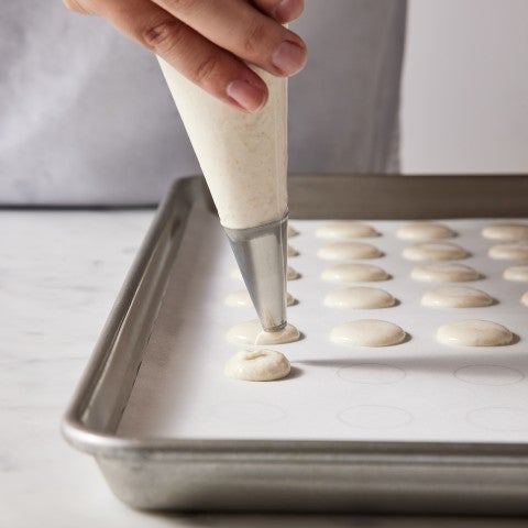 Piping macaron batter - select to zoom