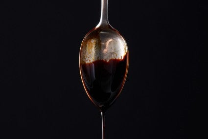 Molasses dripping off a spoon