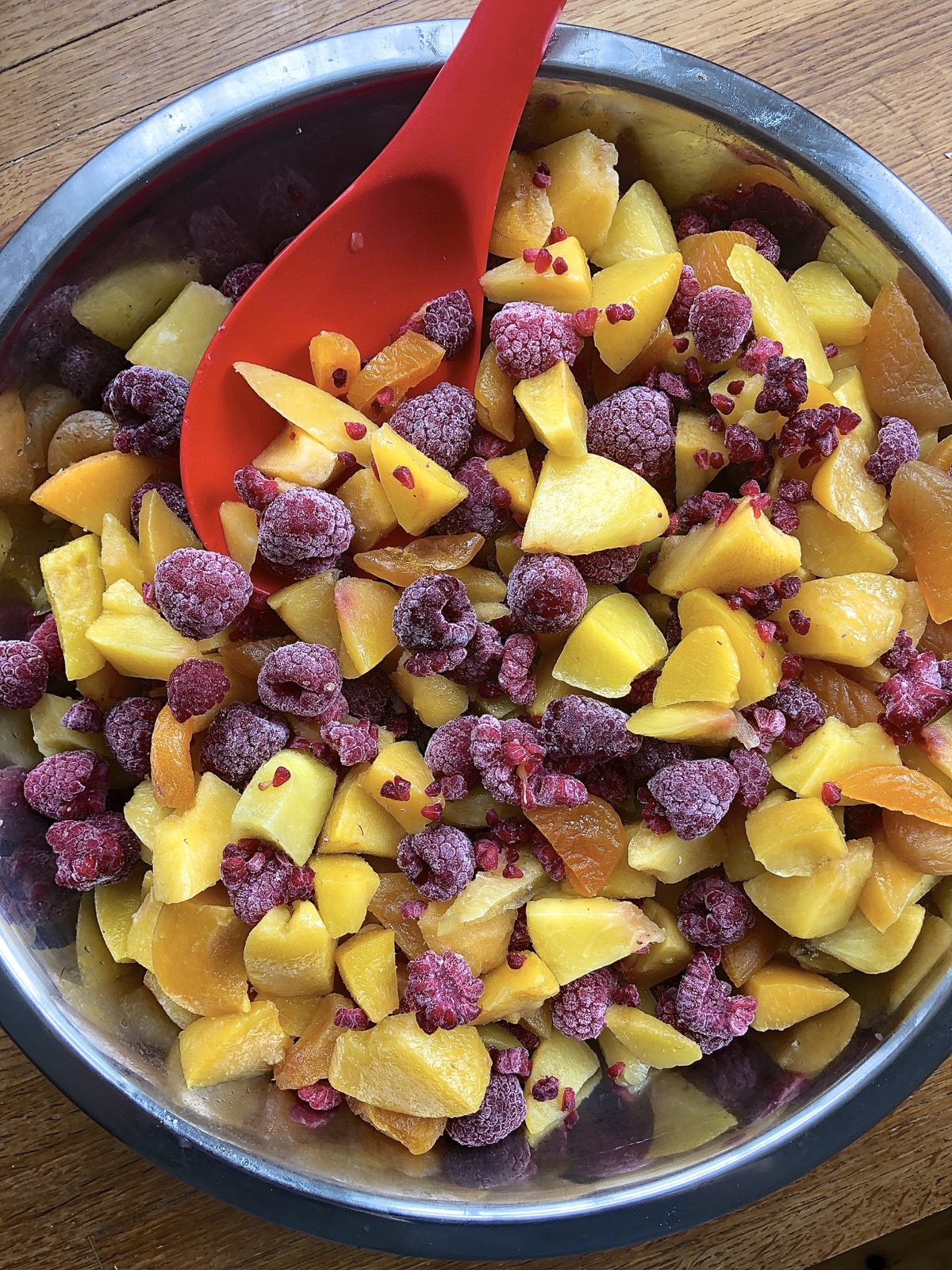 Peach, apricot, and raspberry pie filling in a bowl