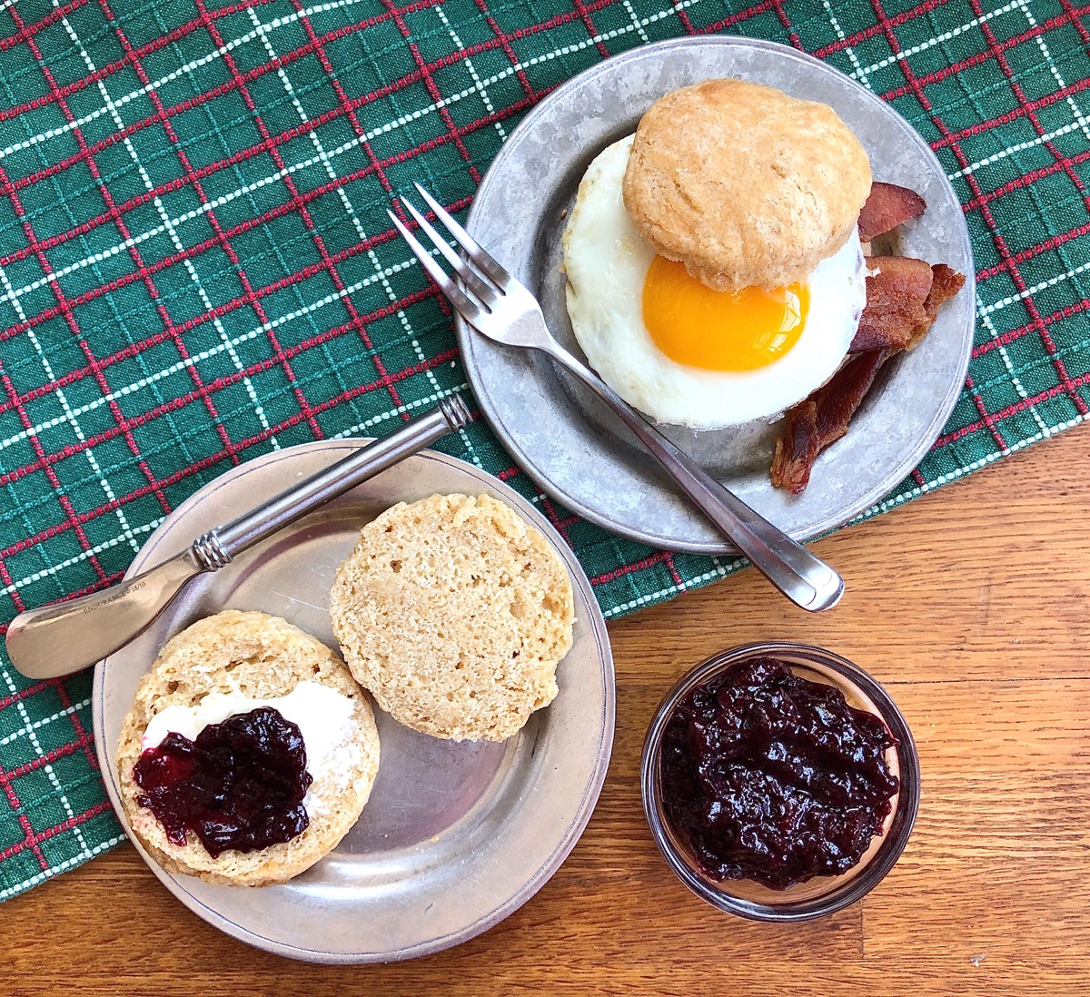Whole wheat sourdough biscuits made into a breakfast sandwich, and simply spread with butter and jam.