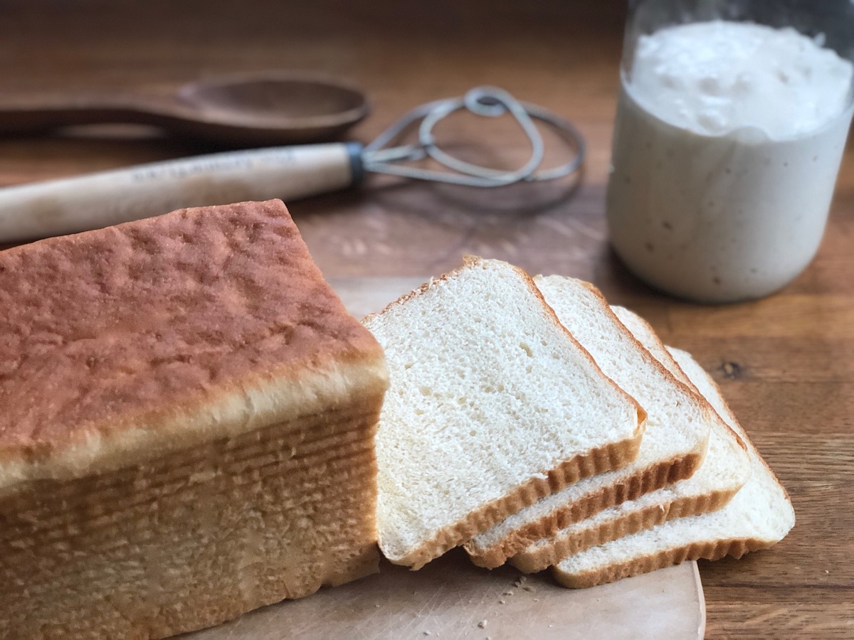 White sandwich bread from a pain de mie pan, sliced on a cutting board