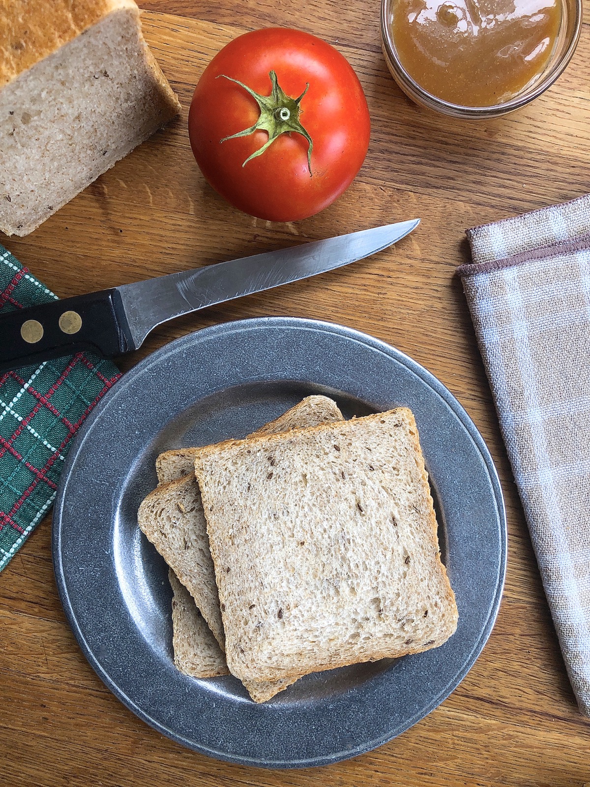 Sliced rye bread on a plate, ready to make into a sandwich.