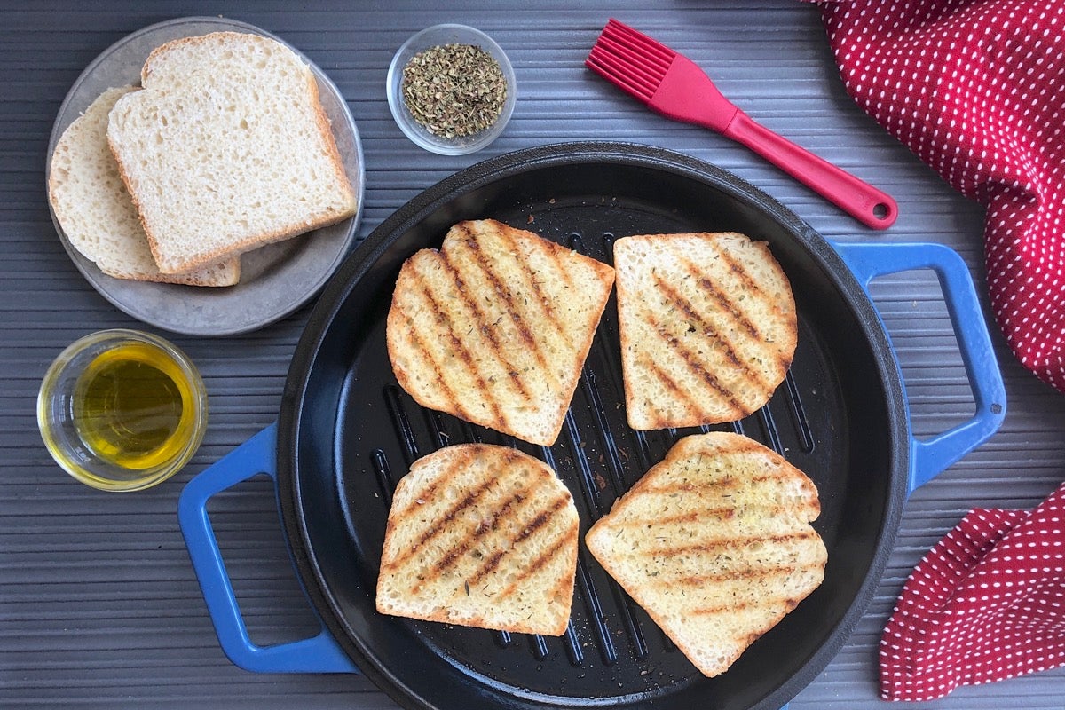 English Muffin Toasting Bread turned into Texas Toast by spreading with  butter, griddling, then sprinkling with Italian herbs and garlic powder.