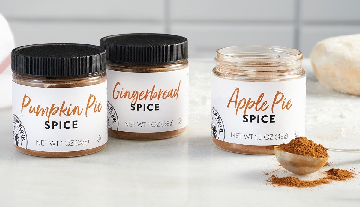 Three jars of spice on a white countertop: Apple Pie Spice, Pumpkin Pie Spice, and Gingerbread Spice