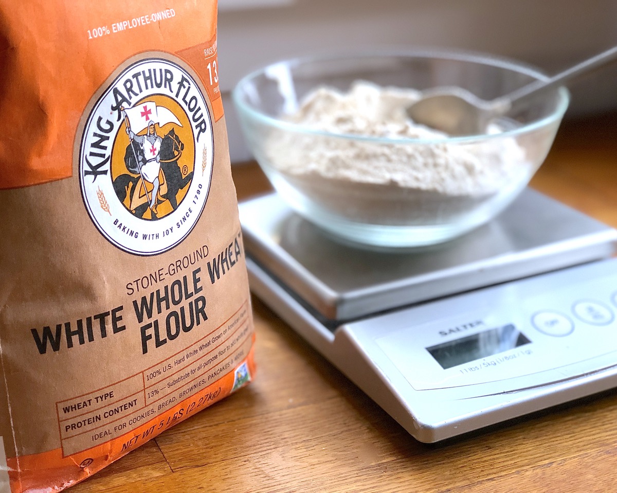 Bag of King Arthur White Whole Wheat Flour, bowl of flour on scale