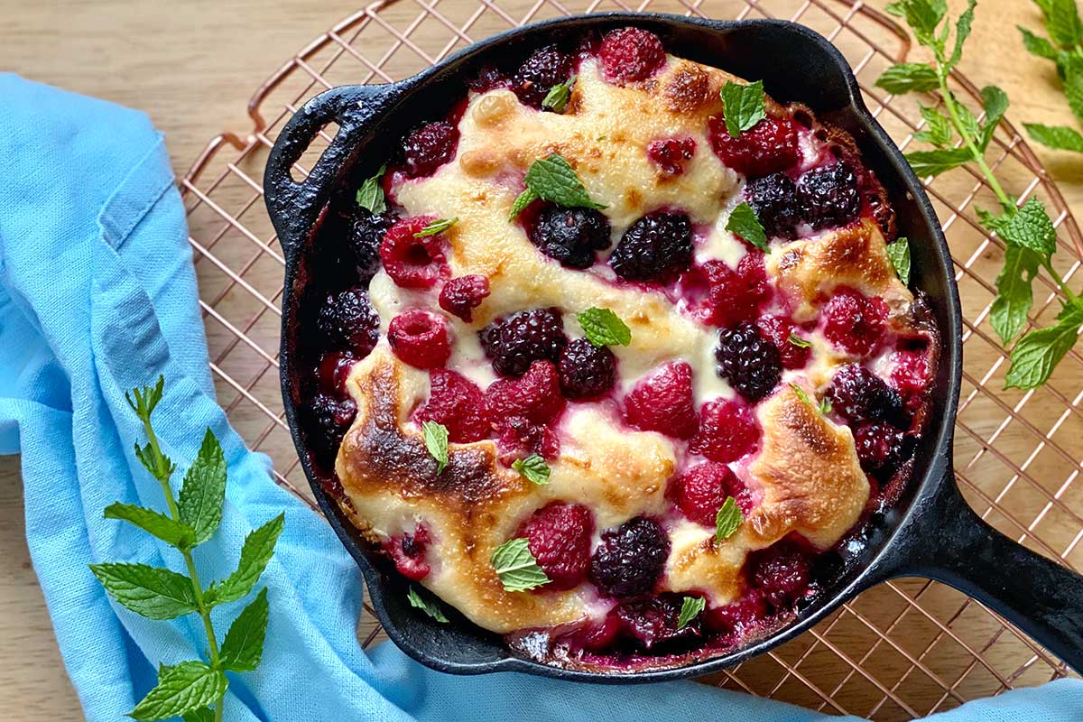 A brunch pizza topped with sweetened mascarpone, fresh berries, and torn mint leaves
