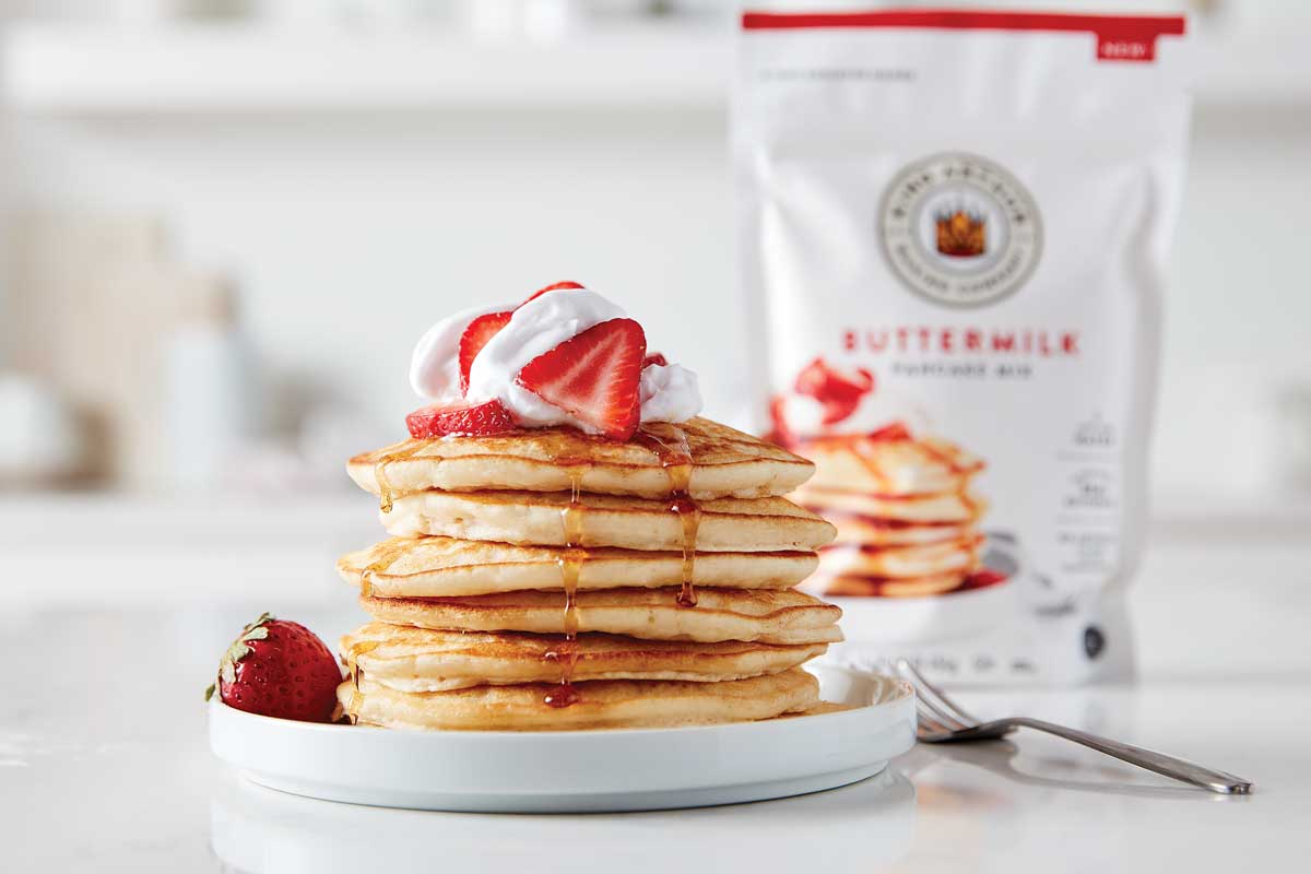 Stack of pancakes with buttermilk mix package in background
