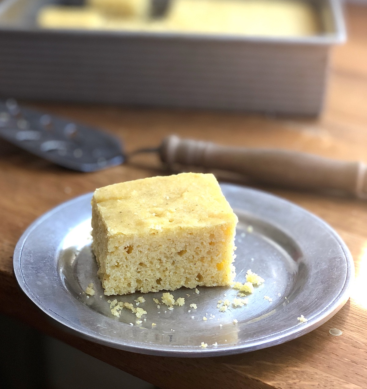Square of cornbread on a plate ready to be served