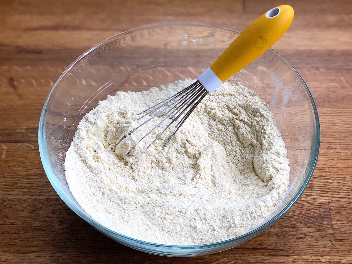 Dry ingredients for cornbread whisked together in a bowl