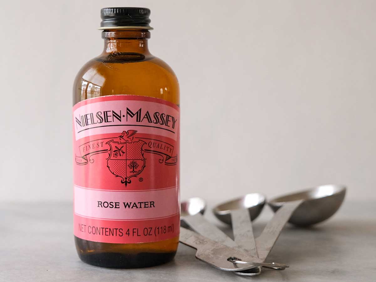 Bottle of rose water on counter