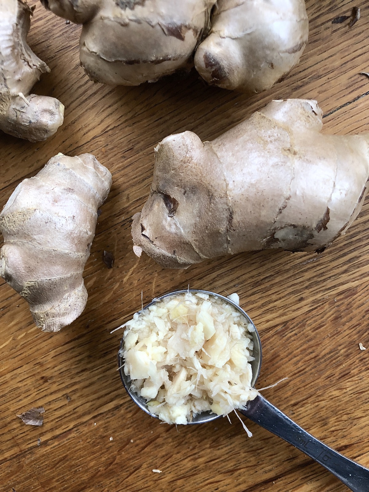 Grated fresh ginger in a tablespoon measure