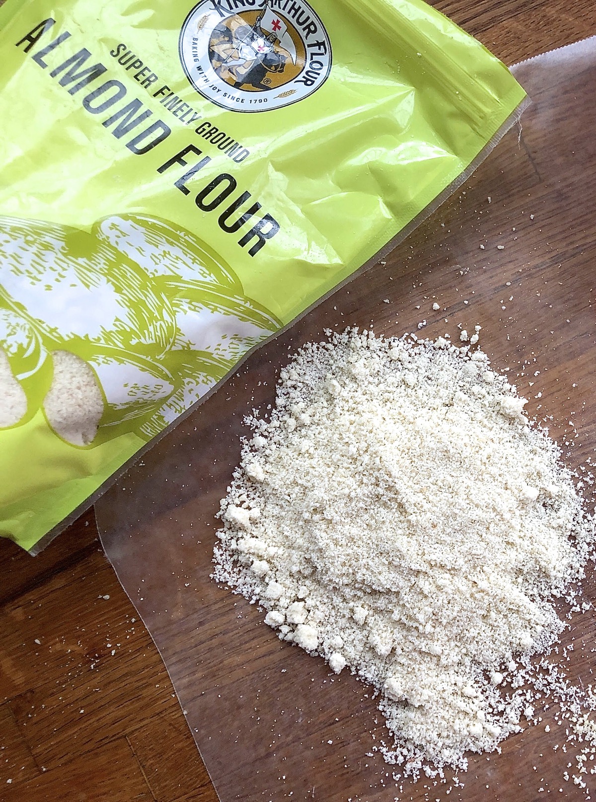 Bag of King Arthur Almond Flour, some spilled out onto a cutting board.