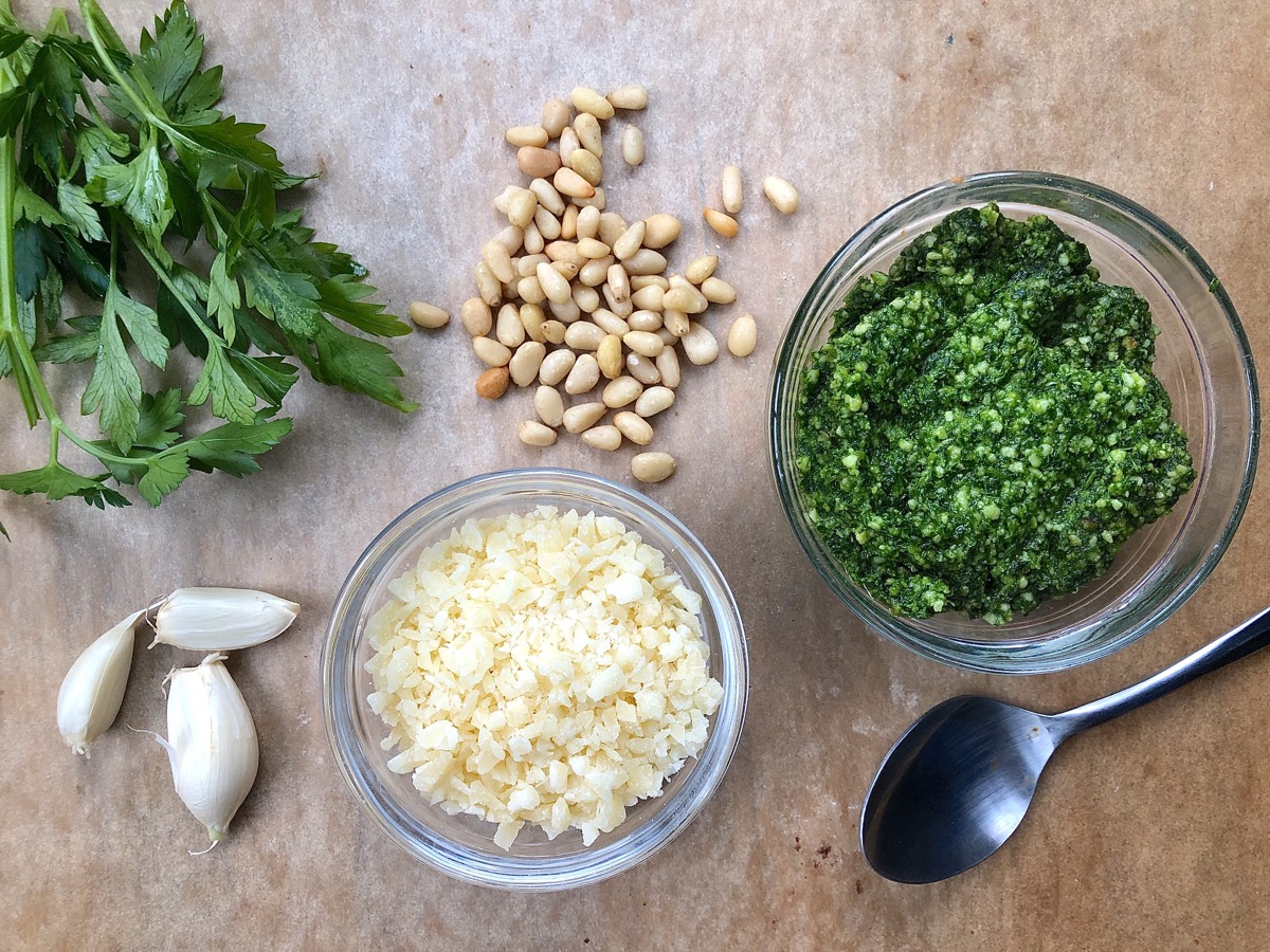 Ingredients for parsley pesto laid out on a table.