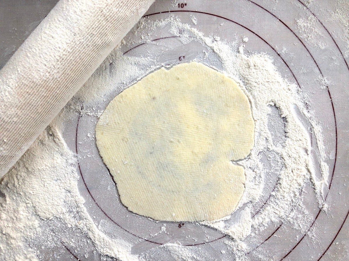 Lefse rolled into a 6" circle on a silicone rolling mat.
