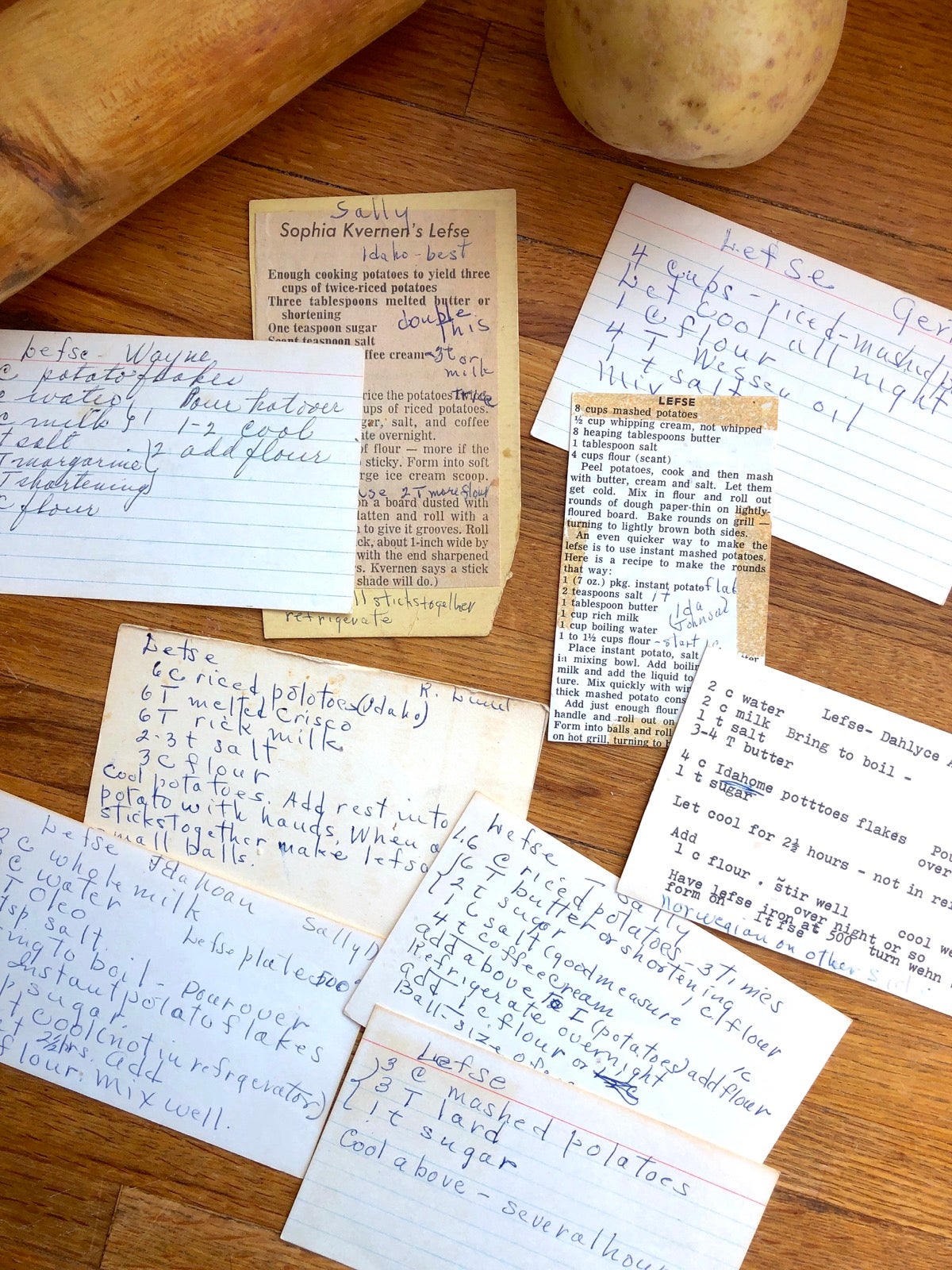 Recipe cards for lefse scattered on a kitchen table.