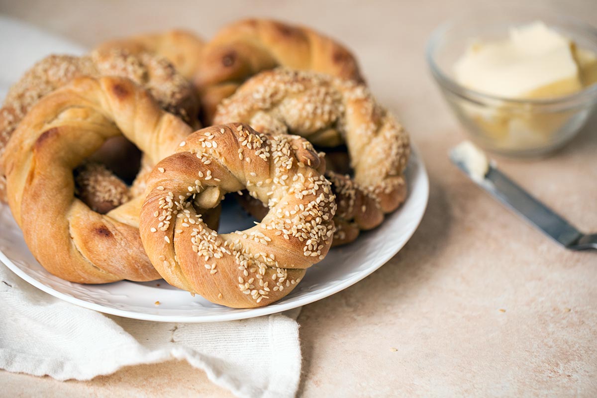 A plate full of homemade Turkish bagels with sesame seeds