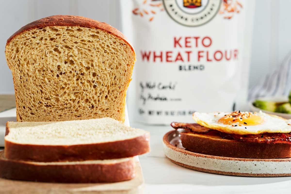 Sliced keto bread with flour in the background