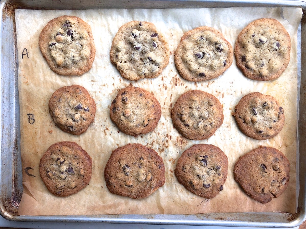 Chocolate chip cookies on a baking sheet; some made with Baking Sugar Alternative, some with regular cane sugar.