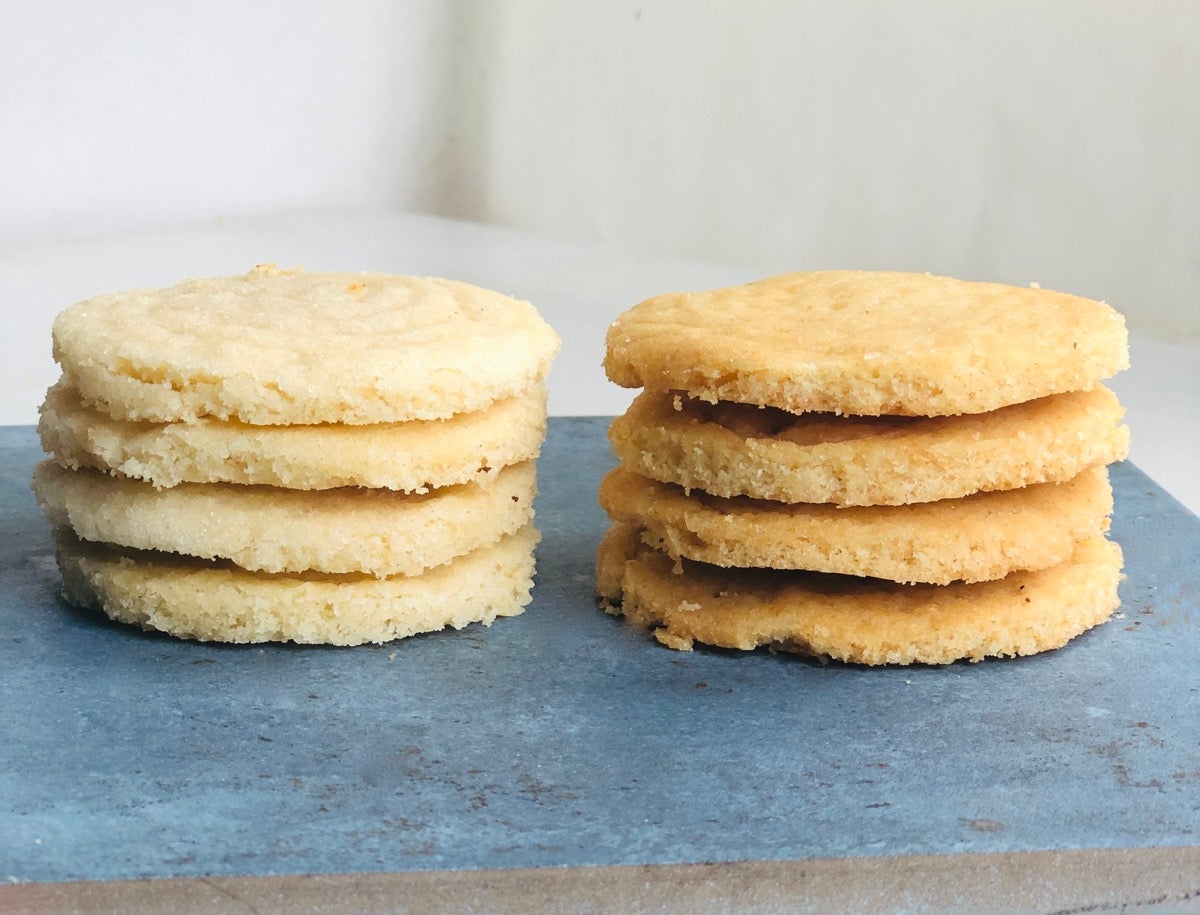 Two stacks of Vanilla Sugar Cookies, one made with Baking Sugar Alternative, one with regular cane sugar.