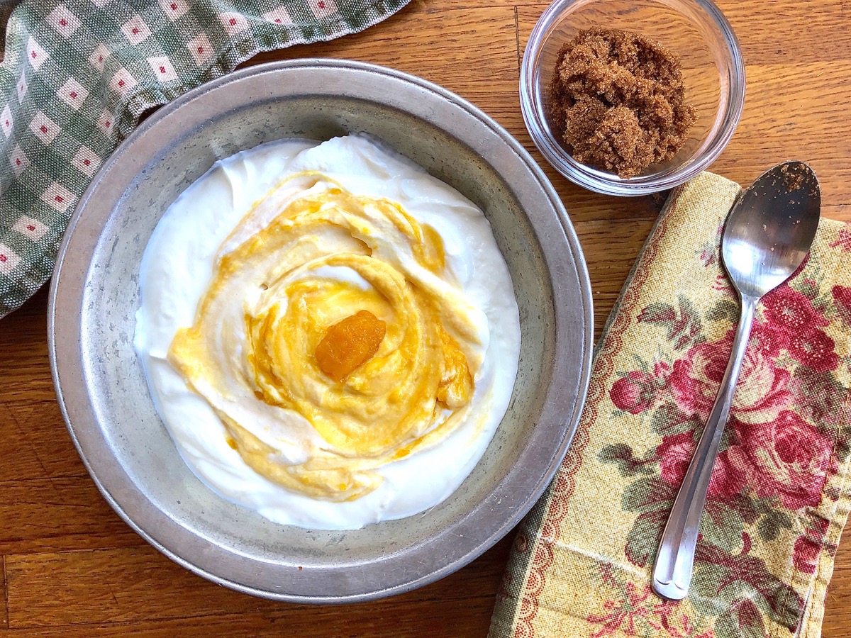 Pumpkin purée swirled into a bowl of Greek yogurt for breakfast.