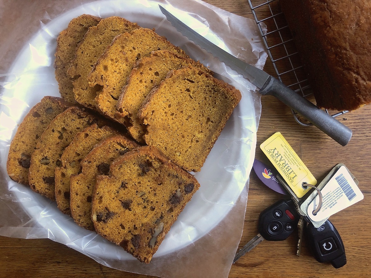 Slices of pumpkin bread on a paper plate, ready to give away