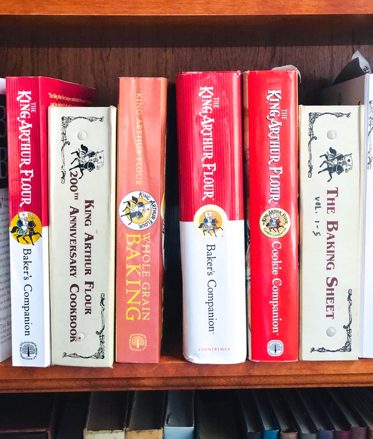 King Arthur cookbooks on a shelf.
