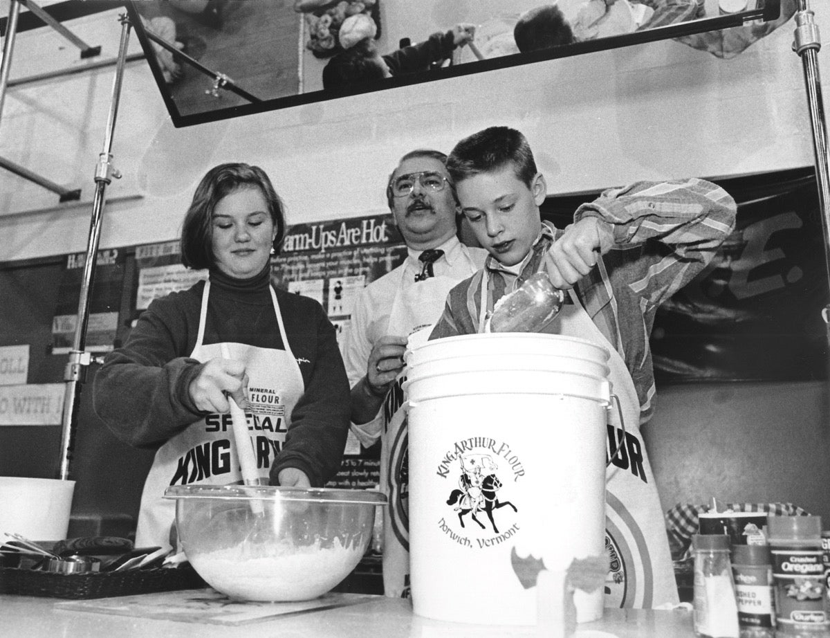 Two students and an adult teacher at a King Arthur bread baking class from 1992.