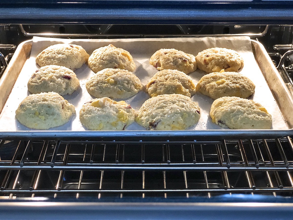 A baking sheet of peach scones in the oven.