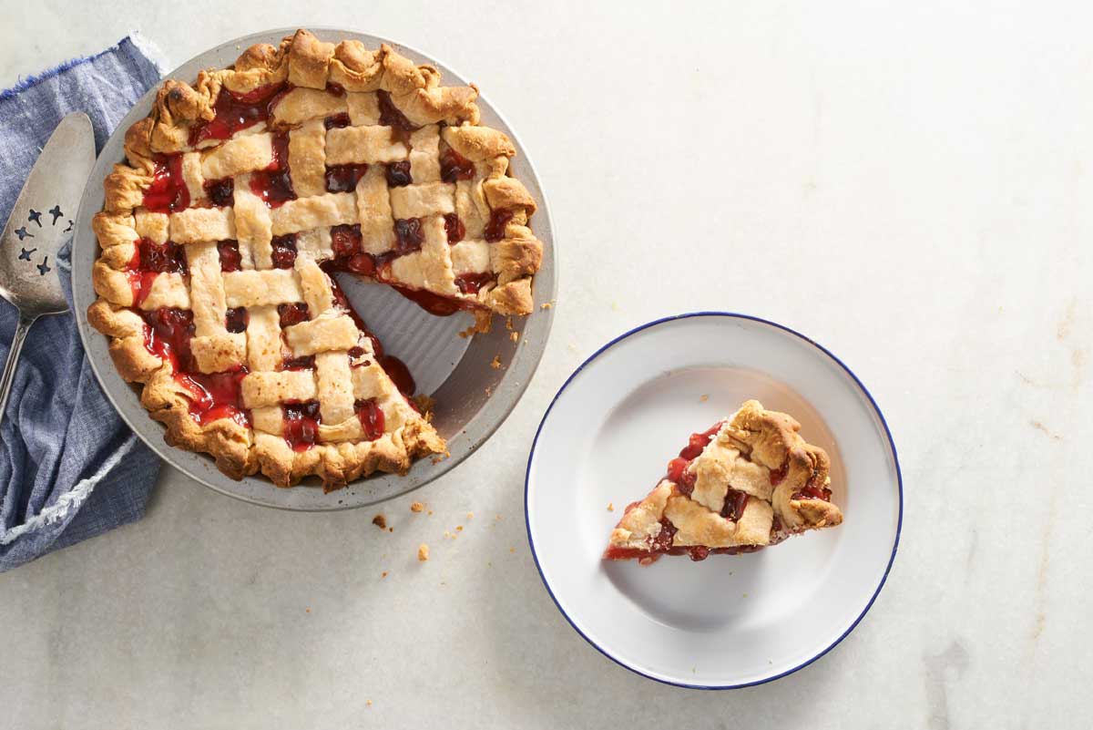 Lattice cherry pie with slice cut out