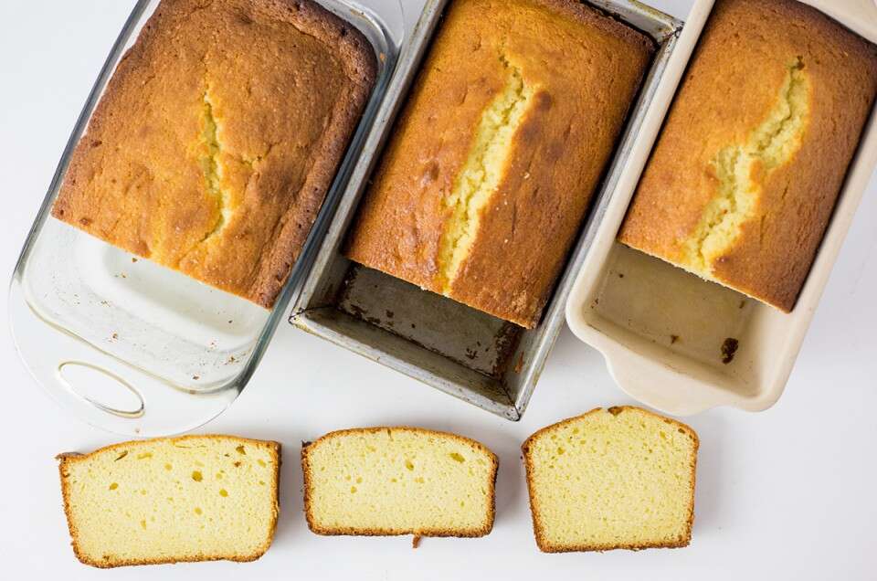 Three pound cakes, side by side, baked in three different pans: metal, glass, and ceramic