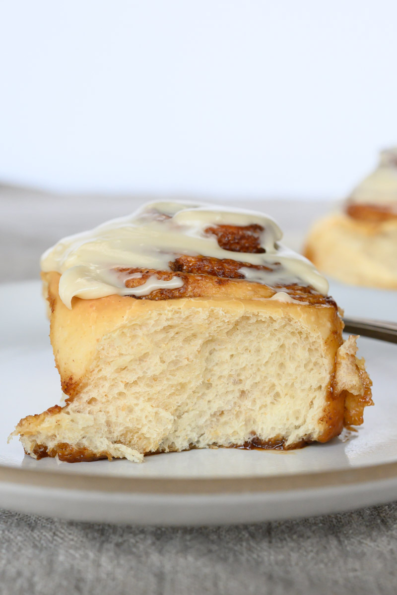 Tender sourdough cinnamon bun topped with icing.
