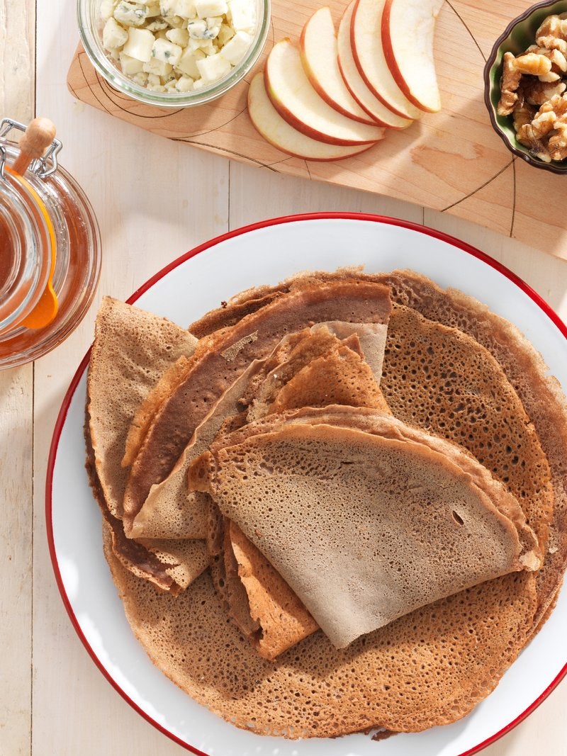 A plate of folded teff crepes, about to be enjoyed