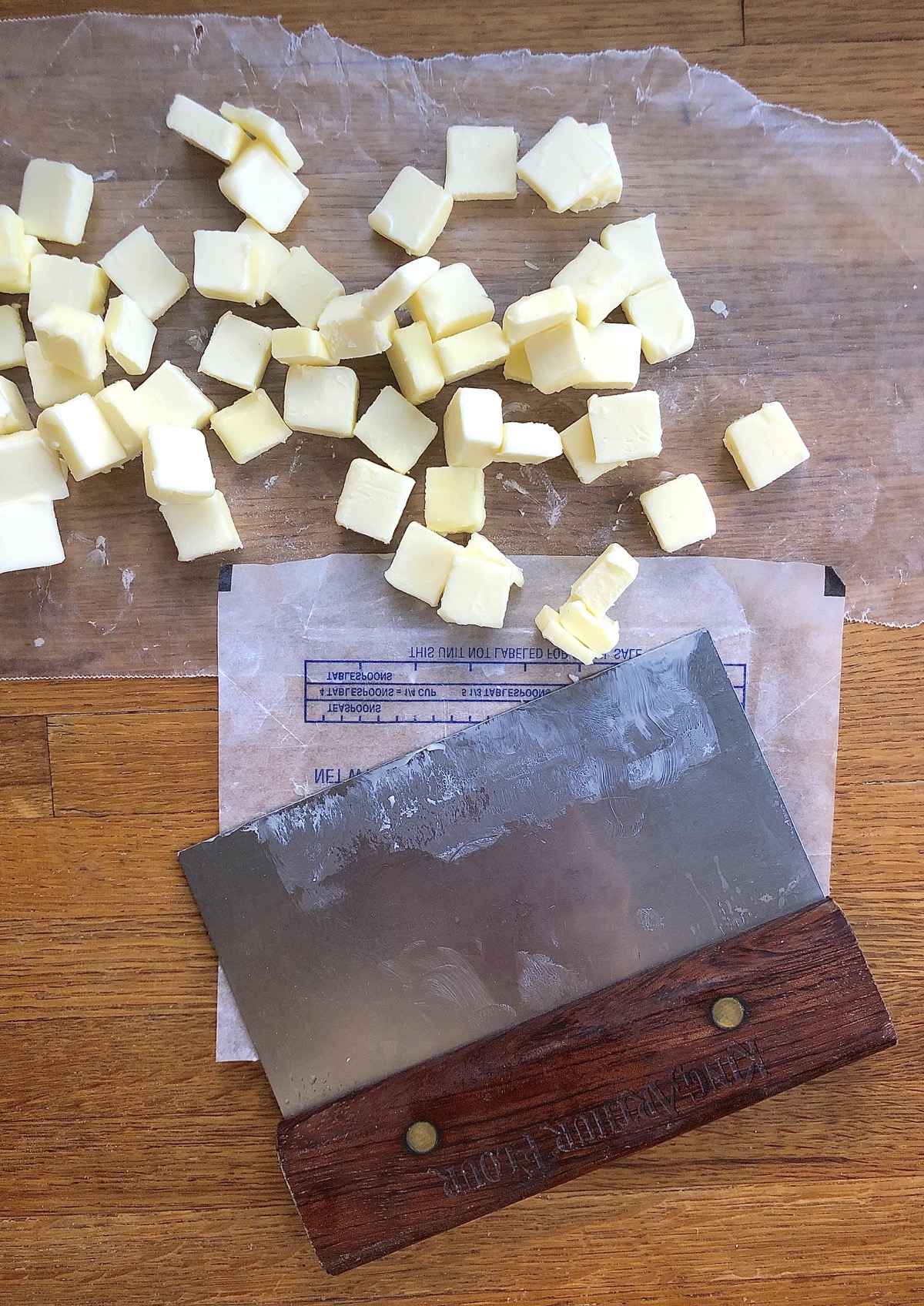 Pile of 1/2" butter cubes with bench knife