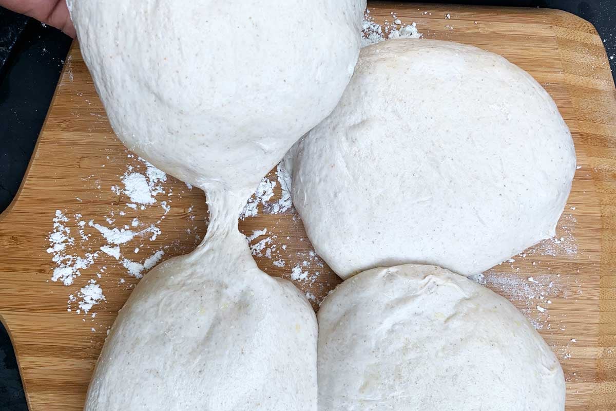 Four balls of dough on a baking surface