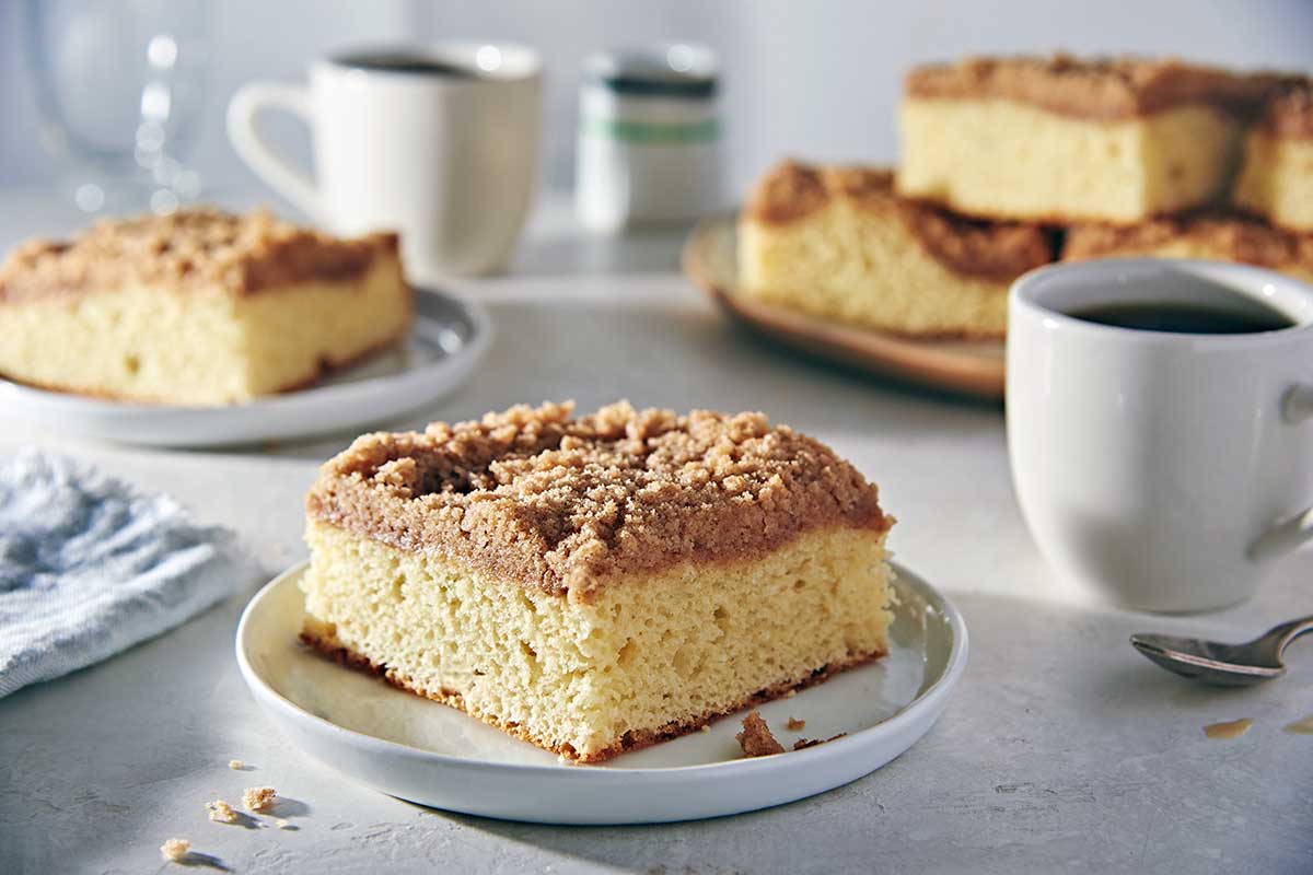 A slice of gluten-free coffeecake with cinnamon streusel topping on a plate