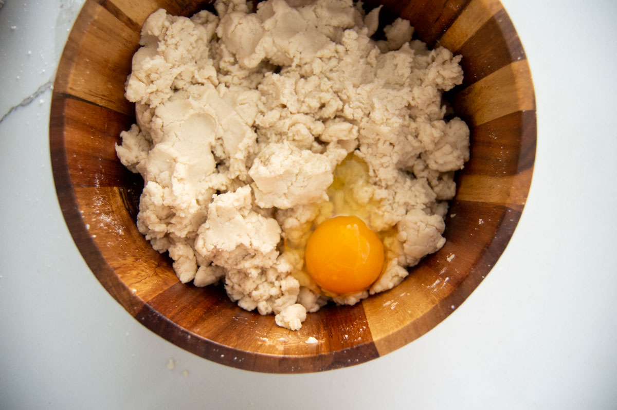 Egg added to dough in bowl