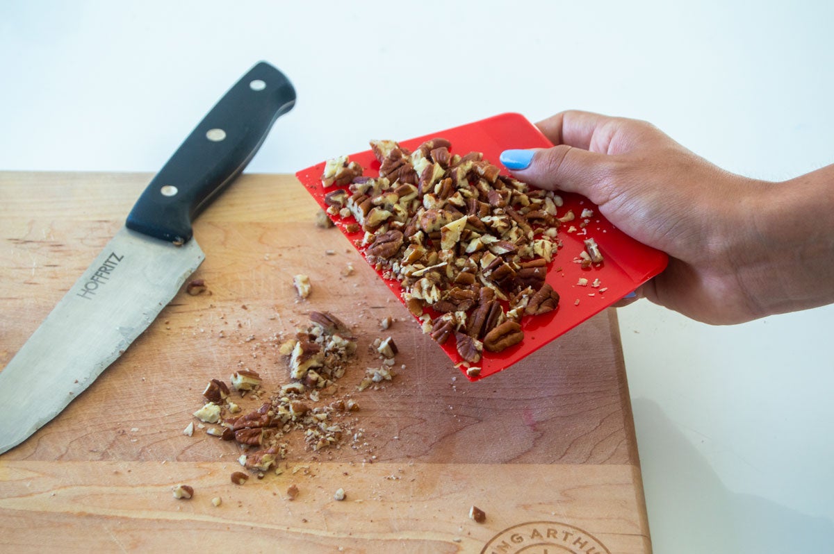 Moving chopped nuts with dough scraper