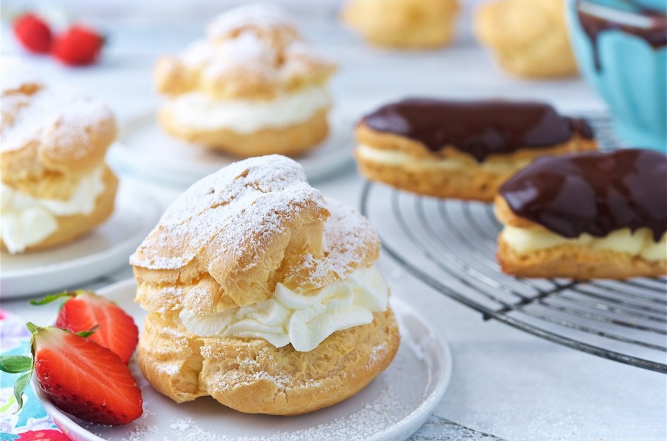 Cream puffs filled with pastry cream and eclairs topped with chocolate