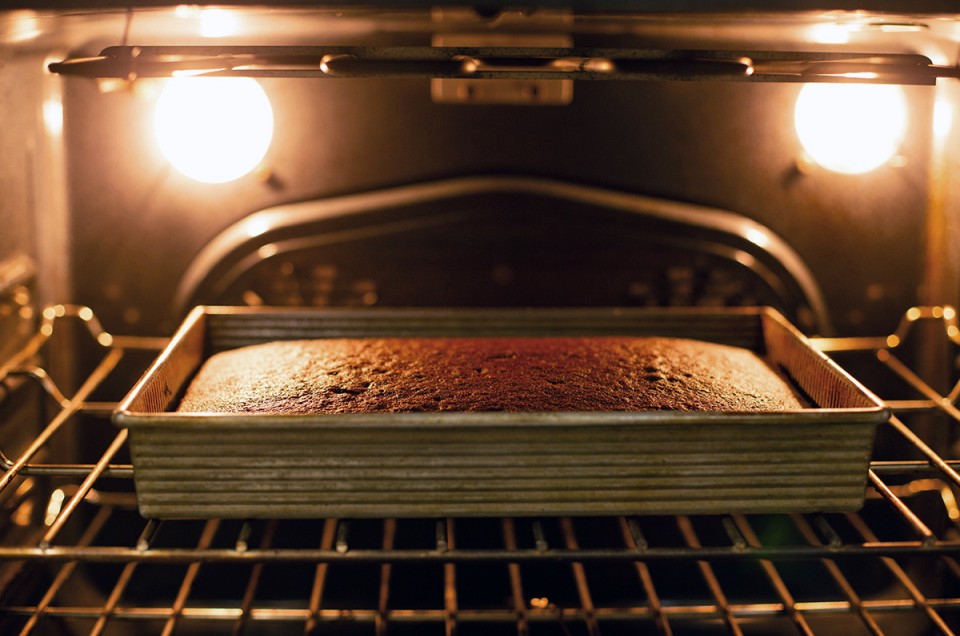 Chocolate sheet cake baking in an oven