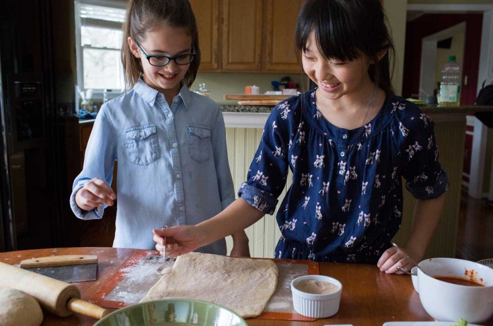 Two young girls baking