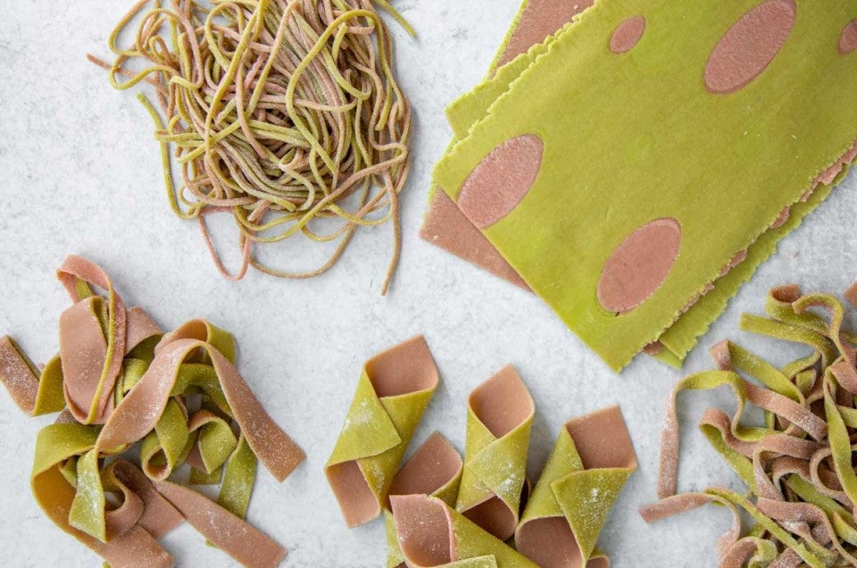 Different shapes of two-toned green and pink pasta