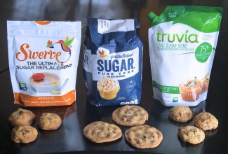 Bags of Swerve sugar replacement, granulated sugar, and Truvia Cane Sugar Blend, all pictured with chocolate chip cookies.