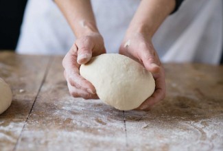 Hand holding bread dough